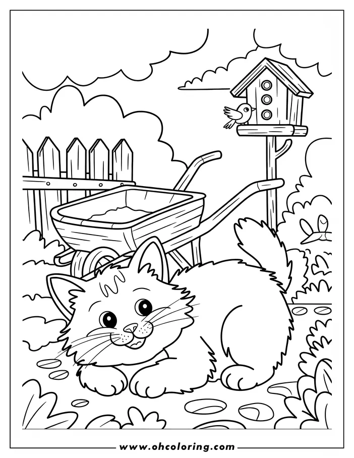 A kitten lies in a garden with a wheelbarrow and a birdhouse with a bird on it.